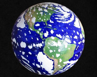 Large, shiny, handmade Earth globe with clouds.