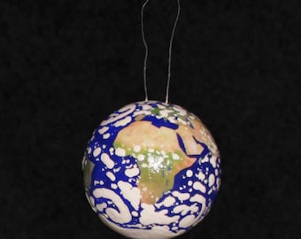 Handmade Earth ornament with clouds.