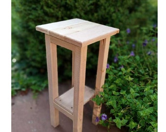 May include: A light wood end table with a shelf. The table has a simple design and is made of natural wood.