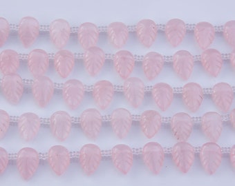 May include: A strand of pink rose quartz beads, each bead is carved in the shape of a leaf.