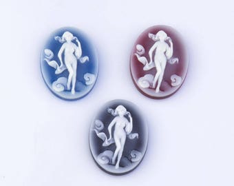 May include: Three oval-shaped cameo pendants with a white raised design of a woman in a flowing dress. The pendants are in blue, red, and black.