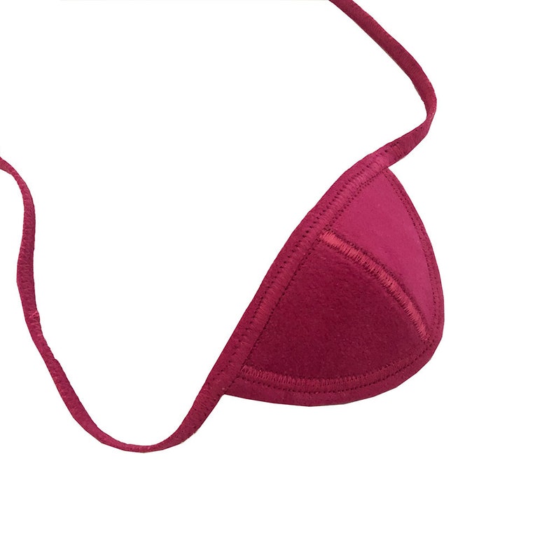 May include: A maroon triangle bikini top with a stitched edge and a thin strap. The top is made of a soft material and is set against a white background.