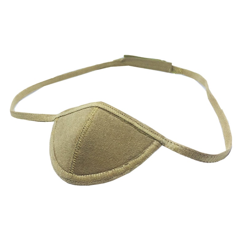May include: A tan eye patch with a stitched border and an adjustable strap. The eye patch is designed to cover one eye and is made of a soft, textured material. The strap is thin and flexible, allowing for a comfortable fit.