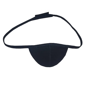 May include: A black eye patch with a curved strap and a Velcro closure. The eye patch is made of a soft, dark fabric and is designed to cover one eye. The strap is thin and adjustable.