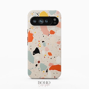May include: A smartphone case featuring a cream-colored background with a multi-colored terrazzo pattern. The design includes irregular shapes in shades of orange, pink, black, yellow, and light blue. The text BOHO Case studio is at the bottom.