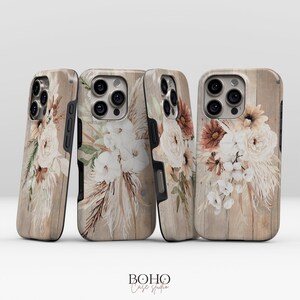 May include: Four phone cases with a floral design. The cases have a wood-grain background and feature bouquets of white, cream, and brown flowers. The cases are from the Boho Case Studio.