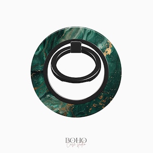 May include: A green and gold marble phone ring holder with a black metal ring. The ring is designed to be used as a stand or grip for a phone.