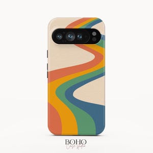 May include: A smartphone case featuring a cream-colored background with a series of wavy, vertical stripes in shades of orange, yellow, green, and blue. The case has a black camera cutout at the top and the text BOHO Case studio at the bottom.