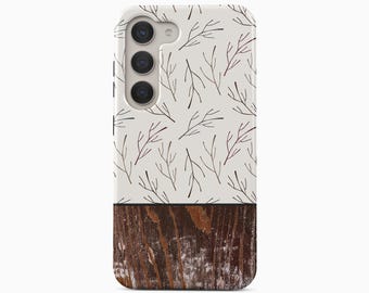 May include: A smartphone case featuring a two-tone design. The top portion is off-white with a repeating pattern of thin, dark brown twig illustrations. The bottom portion displays a dark brown, weathered wood grain texture with visible white distressed details.
