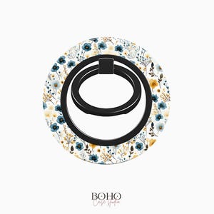 May include: A white phone ring holder with a black ring and a floral pattern in shades of blue and yellow.