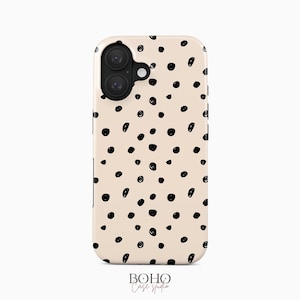 May include: A beige smartphone case featuring a scattered pattern of irregular black ink-style dots. The case has a dual-camera cutout in the upper left corner and the text BOHO Case studio printed in black at the bottom center of the image.