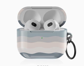 May include: A white and gray striped case for AirPods with a light blue and pink wavy pattern. The case has a small green light and a black ring attached to it.