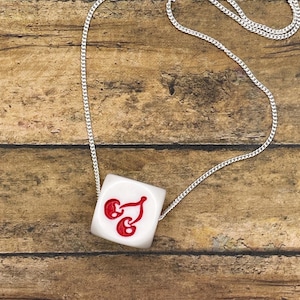 May include: A set of three ceramic mugs with a speckled, matte finish. The mugs are in shades of cream, light gray, and dark gray. Each mug has a simple, minimalist design and a rounded handle.