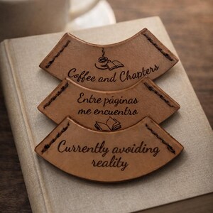 May include: A set of three ceramic mugs with a speckled, matte finish. The mugs are in shades of cream, light gray, and dark gray. Each mug has a simple, minimalist design and a rounded handle.