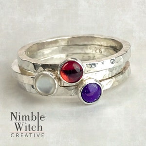 Set of three silver stacking rings with 4mm gemstones in a patriotic red, white, and blue theme. A red Garnet, a blue Lapis Lazuli and a Mother of Pearl.