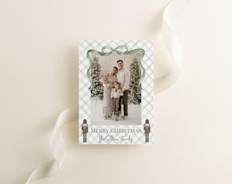 May include: A Christmas card featuring a family portrait within a green plaid border. The card includes a green ribbon and the text "Merry Christmas" and "The Sellers Family". Two toy soldier illustrations are at the bottom.