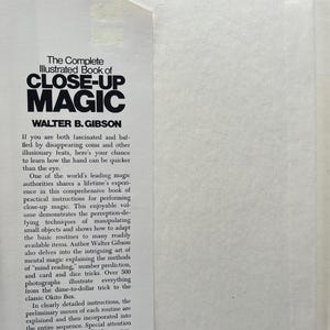 May include: Open book with the title "The Complete Illustrated Book of Close-Up Magic" by Walter B. Gibson. The book's cover features bold, black text on a white background. The text describes the book's content, including instructions for performing close-up magic tricks.