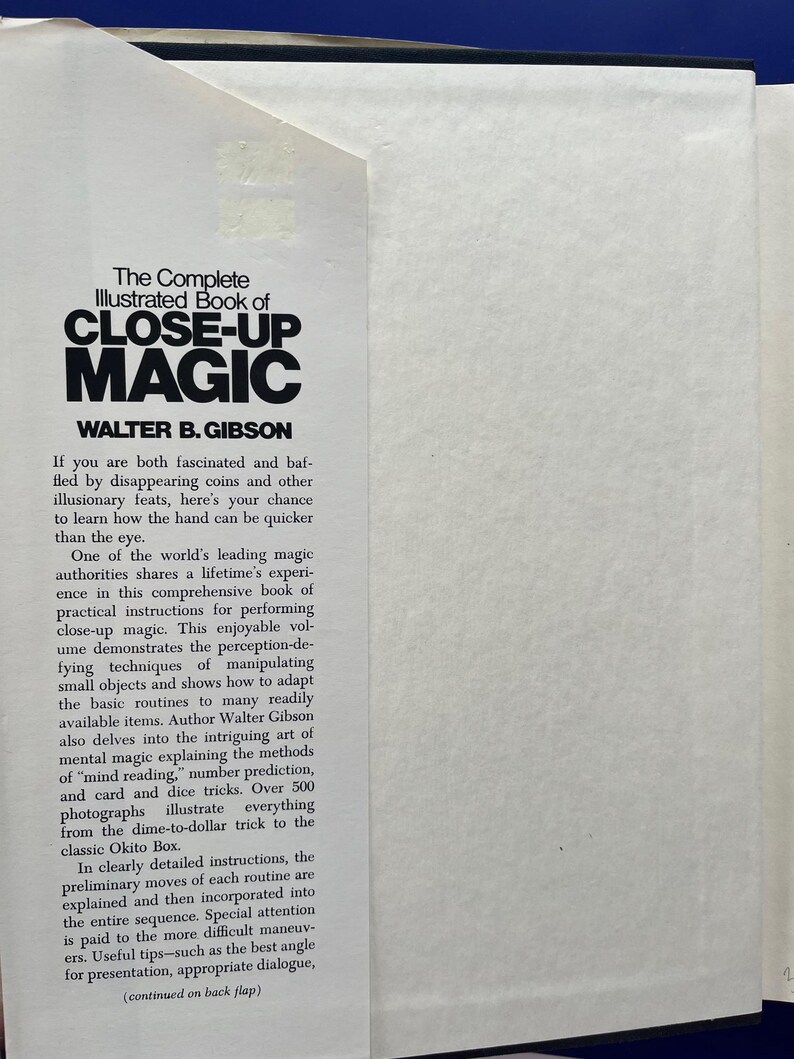 May include: Open book with the title "The Complete Illustrated Book of Close-Up Magic" by Walter B. Gibson. The book's cover features bold, black text on a white background. The text describes the book's content, including instructions for performing close-up magic tricks.