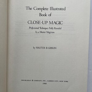 May include: Open book page with text: "The Complete Illustrated Book of CLOSE-UP MAGIC" by Walter B. Gibson. The book's title is in large, bold font. The text "Professional Techniques Fully Revealed by a Master Magician" is also visible. Published in 1980.
