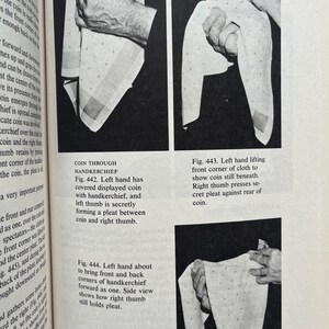 May include: Black and white images from a book demonstrating a coin trick with a handkerchief. The handkerchief has a dotted pattern and is being manipulated by hands to reveal the coin.