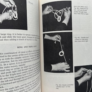 May include: Black and white images from a book on magic tricks. The illustrations show hands manipulating rope and rings to create knots. Text explains the steps for the ring and triple knot.
