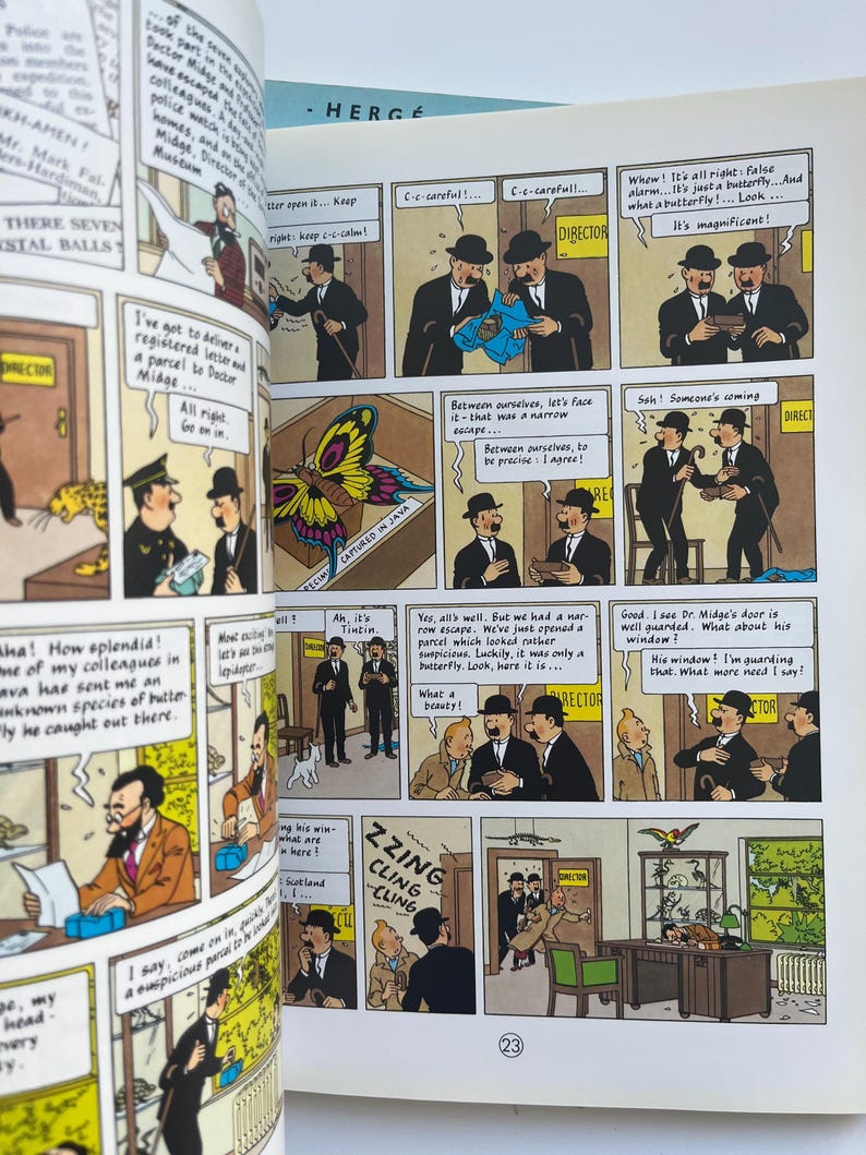 May include: A comic book page from the Tintin series, featuring panels with illustrations and speech bubbles. The panels depict characters in suits and hats, with text in French. A colorful butterfly is also shown.