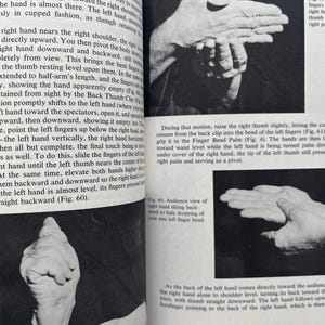 May include: Black and white images of hands demonstrating a magic trick, with text and diagrams. The images show different hand positions and movements, with detailed instructions.