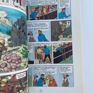 May include: A comic book page featuring panels from a Tintin adventure. The panels depict various scenes with characters in sailor uniforms, a diver, and underwater scenes. Text bubbles contain dialogue.