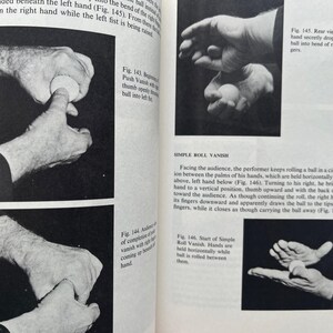 May include: Black and white illustrations from a magic book demonstrate the Simple Roll Vanish. The images show hands manipulating a small ball, with text describing the steps of the trick.