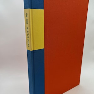 May include: A hardcover book titled "Jim Dine: Selected Poems." The book has a vibrant design with a blue spine, a yellow band, and a bright orange cover. The book is a literary work.