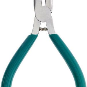 May include: A pair of green handled pliers with pointed tips. The pliers are made of metal and have a spring mechanism.