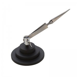 May include: A black and silver bottle stopper with a unique design. The stopper features a tiered, circular base and a silver metal arm that extends upwards, ending in a pointed tip. The design includes a small key detail.