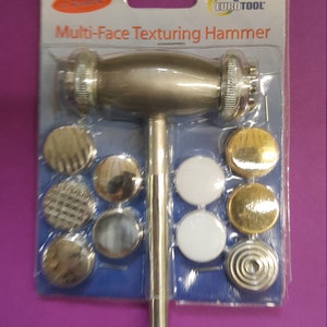 May include: A silver multi-face texturing hammer with a black handle and a variety of interchangeable heads. The heads are displayed on a blue and white card with the text "Eurotool Multi-Face Texturing Hammer".