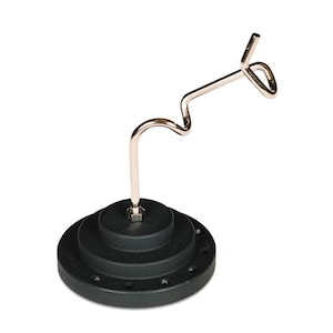 May include: A black, tiered base with a silver metal hook. The hook has a curved design and a loop at the end. The base has multiple circular tiers and small holes around the edge.