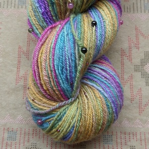 Hand Dyed, Hand Spun, and Beaded Yarn: Contains Tourmaline and Glass Seed Beads. Spun from Polworth Wool and Silk.
