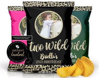 May include: Three chip bags with a leopard print design and gold glitter accents. The center bag is black with a photo of a child and the text "Two Wild Briella's 2ND BIRTHDAY". The bag on the left is pink and the bag on the right is green.