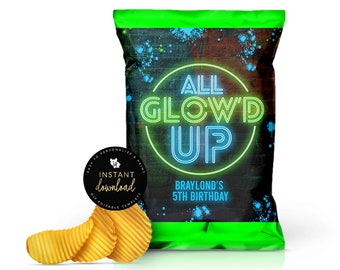 May include: A green chip bag with a black and white background. The bag has a neon blue and green circle with the text "ALL GLOW'D UP" in white. The text "BRAYLOND'S 5TH BIRTHDAY" is below the circle.