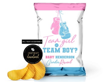 May include: A white chip bag with a pink and blue border. The bag has a graphic of two boxing gloves hanging from a rope. The text on the bag reads "Team girl or TEAM BOY? BABY HENDERSON Gender Reveal".
