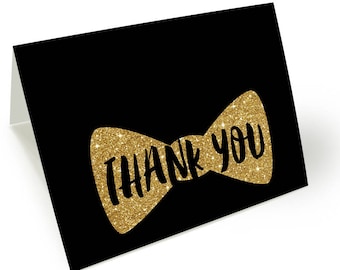 May include: Black thank you card with a gold glitter bow tie design. The text "Thank You" is written in black on the bow tie.