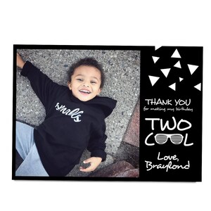 May include: A black and white thank you card with a photo of a young child wearing a black hoodie with the word "smalls" in white lettering. The text on the card reads "Thank you for making my birthday two cool. Love, Braylond."