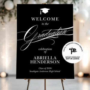 May include: A black graduation welcome sign on a gold easel. The sign features white text that reads "WELCOME to the Graduation celebration of ABRIELLA HENDERSON Class of 2026 Southgate Anderson High School". A digital download icon is in the corner.