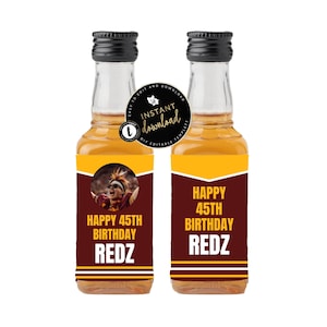 May include: Two miniature liquor bottles with black caps and labels that read "HAPPY 45TH BIRTHDAY REDZ." One label features a person in a sports uniform. The bottles have a clear glass body and a dark amber liquid.