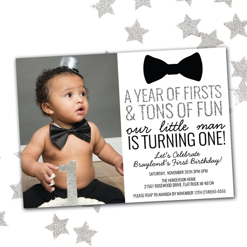 May include: A black and white birthday invitation with a photo of a baby boy wearing a bow tie and a silver top hat. The invitation says "A Year of Firsts & Tons of Fun Our Little Man Is Turning One!" and includes details for the party, including the date, time, location, and RSVP information.