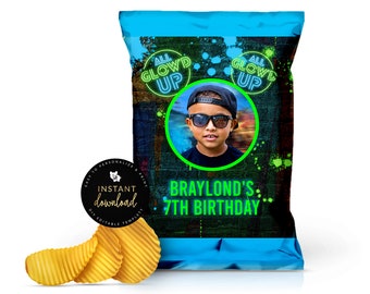 May include: A blue chip bag with a neon green and black design. The bag has a photo of a boy wearing sunglasses and a black hat. The text on the bag reads "All Glow'd Up" and "Braylond's 7th Birthday".