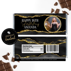 May include: Black and gold chocolate bar wrapper with a photo frame and the text "HAPPY 18TH Birthday AMANDA". The wrapper has a glittery gold design and a nutrition facts label with the text "GOOD VIBES" and "BIRTHDAY FUN".