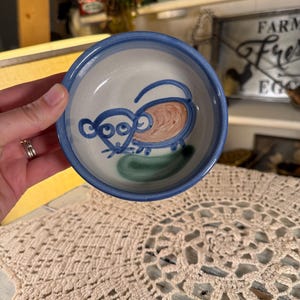 May include: A set of three ceramic mugs with a speckled, matte finish. The mugs are in shades of cream, light gray, and dark gray. Each mug has a simple, minimalist design, perfect for coffee or tea.
