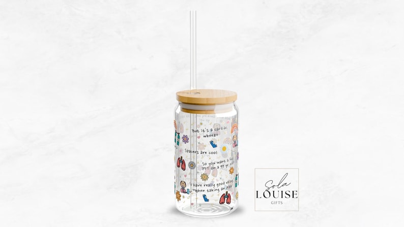 May include: A clear glass reusable water bottle with a bamboo lid and a straw. The bottle is decorated with colorful stickers and text that says "But it's a cute-a-whoops" and "Spikes are cool".