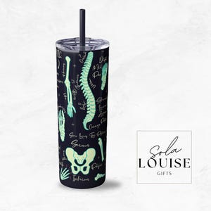 May include: A black and green stainless steel tumbler with a skeletal anatomy design. The tumbler features a variety of bones, including the spine, ribs, and pelvis. The text "Sacrum", "Ilium", "Ischium", "Pubis", "Cervical", "Thoracic", "Lumbar", "Coccyx", "Femur", "Tibia", "Fibula", and "Patella" is printed on the tumbler.
