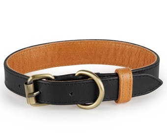 May include: A black leather dog collar with a brown leather lining and a gold metal buckle.