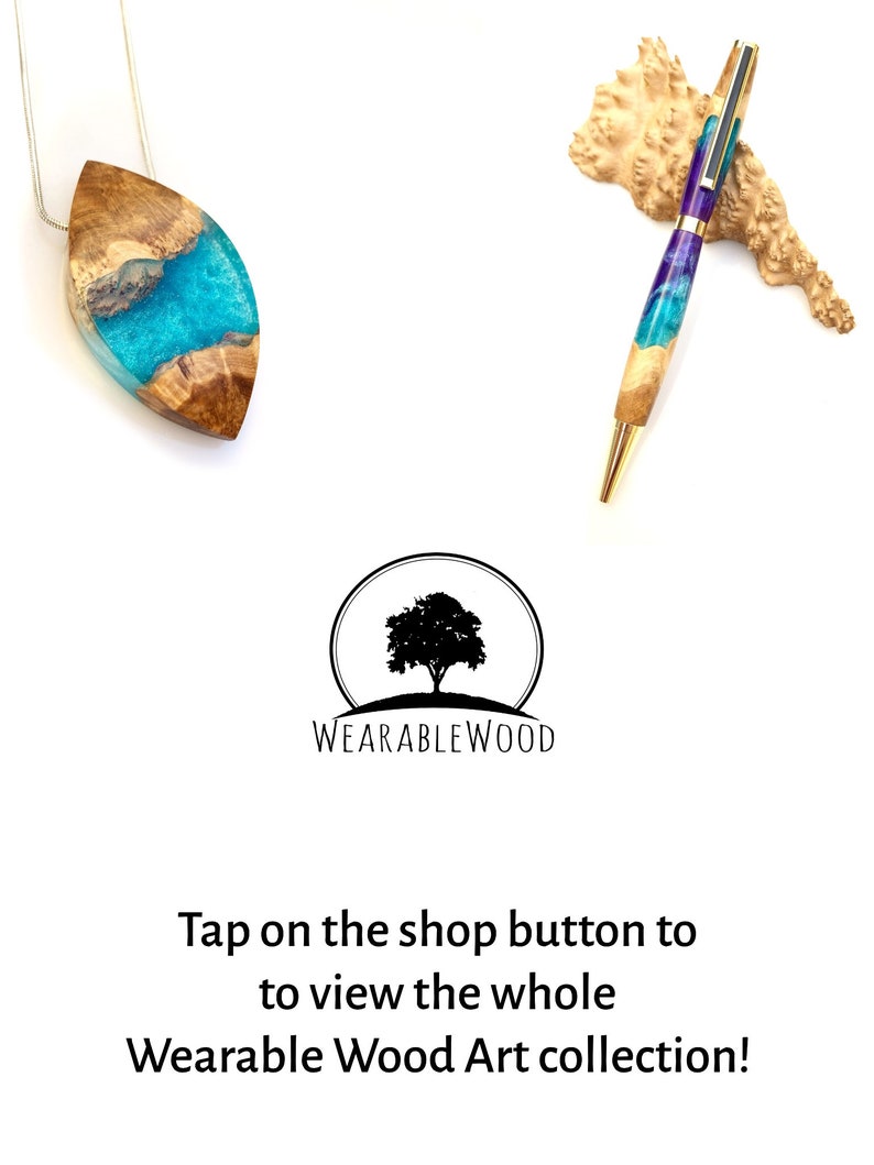 Op de afbeelding: Een teal- en paarse harspen met een gouden rand en een houten basis. De pen rust op een stuk hout. De afbeelding toont ook een teal- en paarse harshanger met een houten basis. De tekst "WEARABLEWOOD" is zichtbaar onder de afbeelding.